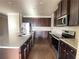 Kitchen with dark wood cabinets, stainless steel appliances and granite countertops at 2677 Pearl Ridge Trce, Buford, GA 30519