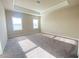 Spacious main bedroom with carpet floor, tray ceilings, and natural light from two large windows at 2677 Pearl Ridge Trce, Buford, GA 30519