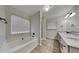 Large primary bathroom with double sink vanity, shower stall, soaking tub, and luxury vinyl flooring at 8541 Glendevon Ct, Riverdale, GA 30274