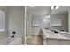 Primary bathroom featuring dual sinks with marble countertops, and a soaking tub at 8541 Glendevon Ct, Riverdale, GA 30274