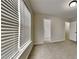 A bright bedroom with large windows, and a carpeted floor at 8541 Glendevon Ct, Riverdale, GA 30274