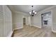 Dining room featuring hardwood floors and a decorative light fixture at 8541 Glendevon Ct, Riverdale, GA 30274