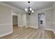 Dining room with traditional crown molding and a chandelier at 8541 Glendevon Ct, Riverdale, GA 30274