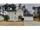 Two-story home with a well-manicured front yard and attached two car garage at 8541 Glendevon Ct, Riverdale, GA 30274