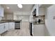 Cozy kitchen featuring stainless steel appliances, white cabinets, and granite countertops at 8541 Glendevon Ct, Riverdale, GA 30274