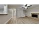 Spacious living room featuring a stone fireplace, ceiling fan, and hardwood floors at 8541 Glendevon Ct, Riverdale, GA 30274