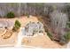 Aerial view of a large home with a well-manicured lawn, mature trees, and a long driveway at 1227 Castle Point Sw Ct, Conyers, GA 30094