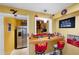 Basement bar area with a counter and stools, stainless steel refrigerator, and charming decor at 1227 Castle Point Sw Ct, Conyers, GA 30094