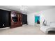 Basement area featuring a dark entertainment area, tiled floors, and bright bedroom doorway at 1227 Castle Point Sw Ct, Conyers, GA 30094