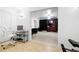 Open basement space with a white swivel chair, neutral tiled floors, and visible entertainment area at 1227 Castle Point Sw Ct, Conyers, GA 30094