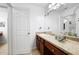 Clean bathroom with light countertops, wood cabinets, and tiled floors at 1227 Castle Point Sw Ct, Conyers, GA 30094