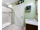 The bathroom features a tiled shower, neutral tile flooring, and fresh paint at 1227 Castle Point Sw Ct, Conyers, GA 30094