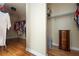 Spacious walk-in closet with hardwood floors, wire shelving, and hanging rods at 1227 Castle Point Sw Ct, Conyers, GA 30094