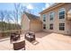 Back of this two-story home with a wooden deck featuring outdoor furniture at 1227 Castle Point Sw Ct, Conyers, GA 30094