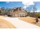 Charming brick home featuring a long driveway and a three-car garage at 1227 Castle Point Sw Ct, Conyers, GA 30094
