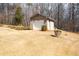 Detached garage with a light brick facade and white garage doors at 1227 Castle Point Sw Ct, Conyers, GA 30094