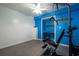 Brightly lit home gym featuring white and blue walls and exercise equipment at 1227 Castle Point Sw Ct, Conyers, GA 30094