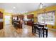 Open kitchen features wood cabinets, granite countertops, hardwood floors, breakfast bar, and adjacent breakfast nook at 1227 Castle Point Sw Ct, Conyers, GA 30094