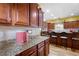 Modern kitchen with custom cabinets, granite countertops, and a breakfast bar at 1227 Castle Point Sw Ct, Conyers, GA 30094
