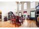 Open living room with hardwood floors, tall windows, and lots of natural light at 1227 Castle Point Sw Ct, Conyers, GA 30094
