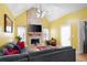 Inviting living room with brick fireplace, mounted TV, hardwood floors, high ceilings, and comfortable sofa at 1227 Castle Point Sw Ct, Conyers, GA 30094