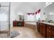 Elegant bathroom features a glass shower, a large soaking tub and double sink granite vanity at 1227 Castle Point Sw Ct, Conyers, GA 30094