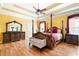 Spacious bedroom with hardwood floors, trey ceiling, decorative ceiling fan, and large windows at 1227 Castle Point Sw Ct, Conyers, GA 30094