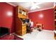 This home office features a built-in desk, shelving, and great natural light at 1227 Castle Point Sw Ct, Conyers, GA 30094