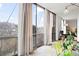 Enclosed balcony showing sliding glass doors, curtains and potted plants at 130 26Th Nw St # 511, Atlanta, GA 30309
