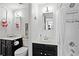 Bathroom featuring dual vanities, a subway-tiled shower and black fixtures at 130 26Th Nw St # 511, Atlanta, GA 30309