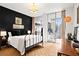 Bedroom featuring a black accent wall, light wood floors and a glass sliding door to the balcony at 130 26Th Nw St # 511, Atlanta, GA 30309