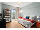 Bright bedroom with wood floors and a sliding glass door to the balcony at 130 26Th Nw St # 511, Atlanta, GA 30309