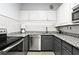 Modern kitchen featuring stainless steel appliances, granite countertops and tile backsplash at 130 26Th Nw St # 511, Atlanta, GA 30309