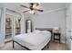 Bright bedroom with a ceiling fan, neutral walls, and access to a private balcony at 2232 Dunseath Nw Ave # 302, Atlanta, GA 30318