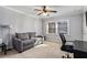 Comfortable bedroom with a gray sofa, carpet, and a large window at 2232 Dunseath Nw Ave # 302, Atlanta, GA 30318