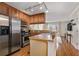 Well-equipped kitchen with wood cabinets, stainless steel appliances, and hardwood floors at 2232 Dunseath Nw Ave # 302, Atlanta, GA 30318