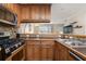 Functional kitchen with wood cabinets, stainless steel appliances, and a tile backsplash at 2232 Dunseath Nw Ave # 302, Atlanta, GA 30318