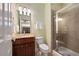 Cozy bathroom featuring tiled shower with glass door, granite vanity top, and warm paint color at 2316 Limehurst Ne Dr, Atlanta, GA 30319