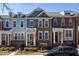 Row of townhouses showing varied exterior finishes, porches, and landscaping on a sunny day at 2316 Limehurst Ne Dr, Atlanta, GA 30319