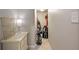 Hallway with white chest of drawers with gold accents and walk-in storage space with household and sports items at 2316 Limehurst Ne Dr, Atlanta, GA 30319