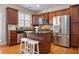 This modern kitchen features stainless steel appliances, wood cabinets, and granite countertops at 2316 Limehurst Ne Dr, Atlanta, GA 30319