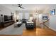 Open-concept living room featuring a large sectional sofa, hardwood floors, and staircase access at 2316 Limehurst Ne Dr, Atlanta, GA 30319