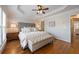 Comfortable main bedroom featuring tray ceiling, fan, and stylish decor at 2316 Limehurst Ne Dr, Atlanta, GA 30319