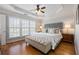 Spacious main bedroom with a ceiling fan, tray ceiling, and multiple windows at 2316 Limehurst Ne Dr, Atlanta, GA 30319