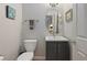 Stylish powder room features a gray vanity, oval mirror, and modern fixtures at 2316 Limehurst Ne Dr, Atlanta, GA 30319