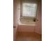 Bright bathroom with large tub, window, and neutral decor at 114 Crescent Woode Way, Dallas, GA 30157