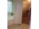 Bright bathroom with a large soaking tub and an open doorway to a walk-in closet at 114 Crescent Woode Way, Dallas, GA 30157