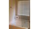 Bright bathroom with large tub, window, and neutral decor at 114 Crescent Woode Way, Dallas, GA 30157