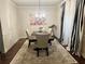 Dining room features a patterned rug, large table, chandelier and striped curtains at 114 Crescent Woode Way, Dallas, GA 30157