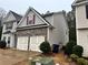 Exterior view of a two-story home with a two-car garage and stone and gray siding at 114 Crescent Woode Way, Dallas, GA 30157